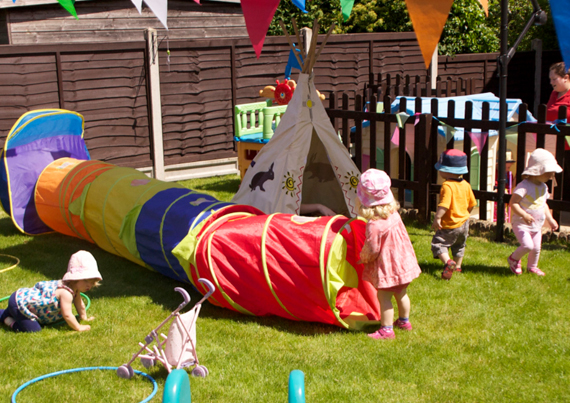 children playing outside at apple trees childcare flamstead