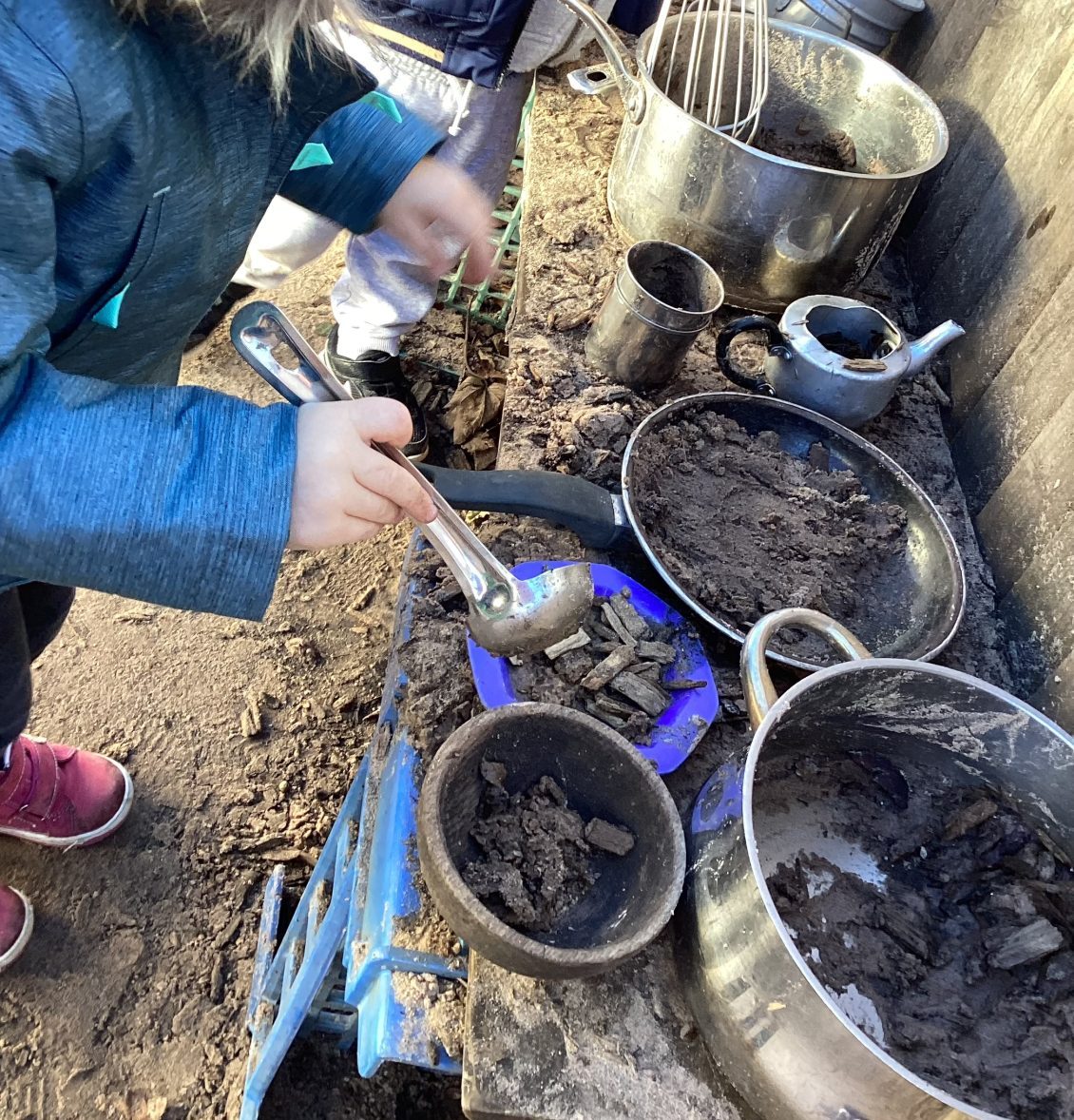 Children playing in a mud kitchen